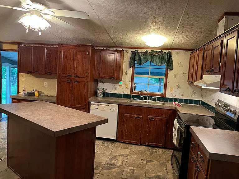The kitchen is so spacious! The island adds even more counter space, or a nice place to pull up a stool and chat while cooking!!
