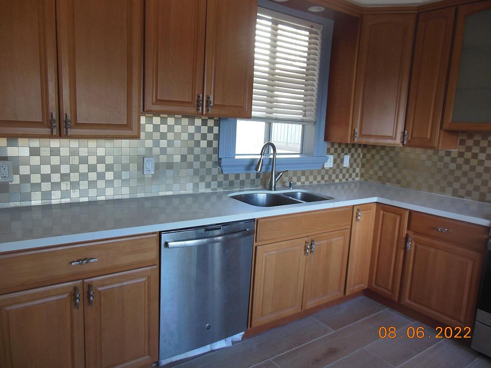 Kitchen with quartz countertop and dishwasher.