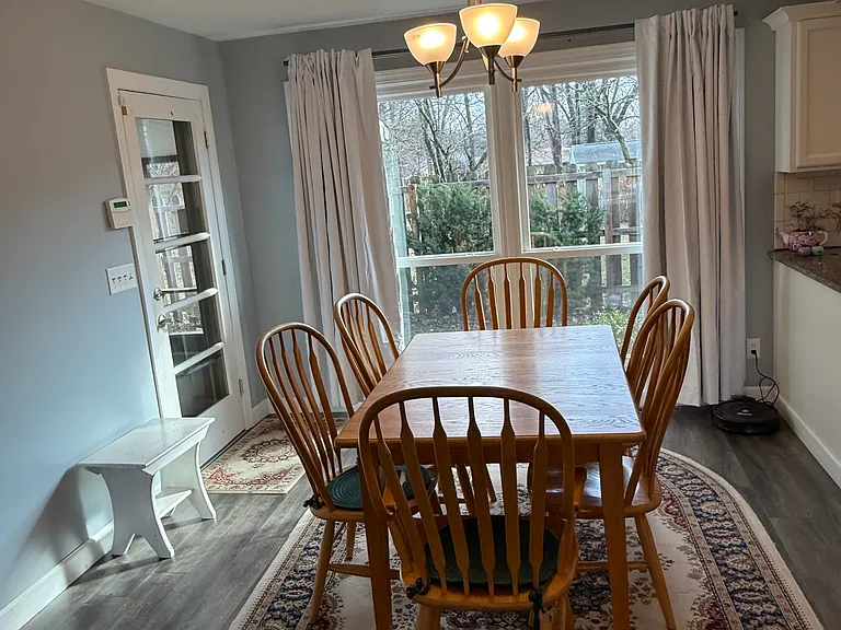Dining area off of the kitchen with door to the screened in porch and two car garage