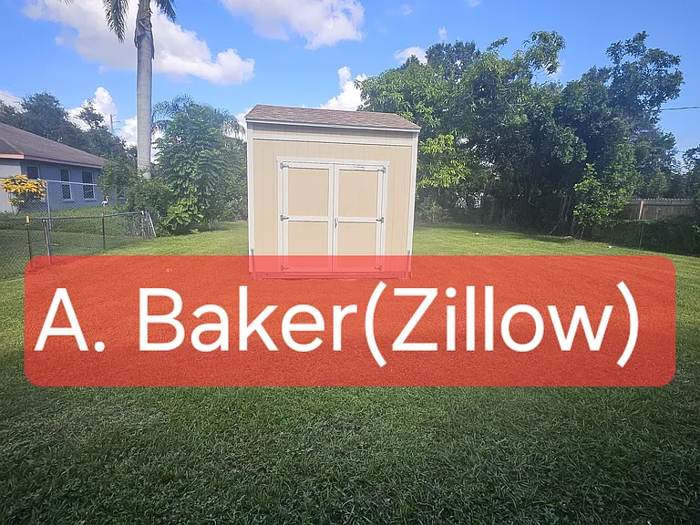 Large fenced in backyard with detached storage unit