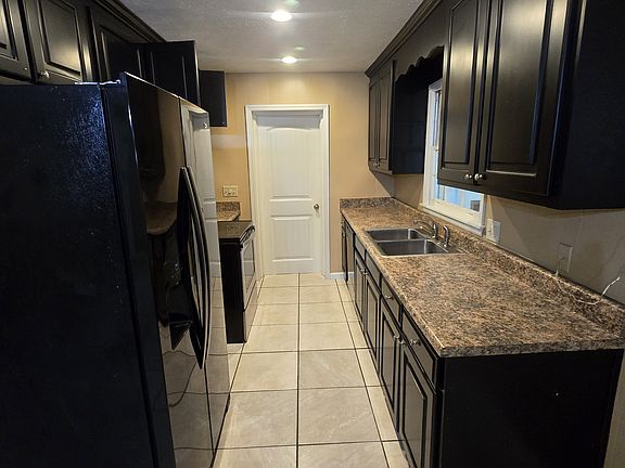 Kitchen with updated appliances refrigerator, stove and dishwasher.