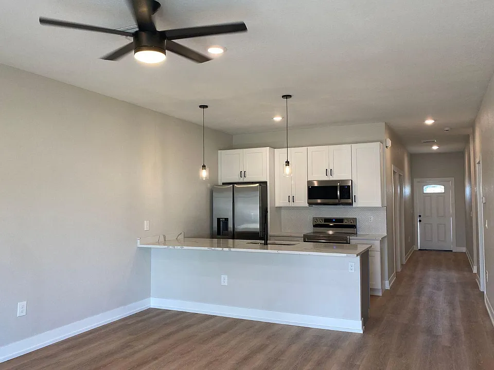 View of kitchen and entrance door.