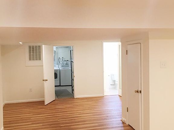 beautiful renovated basement with washer dryer in back