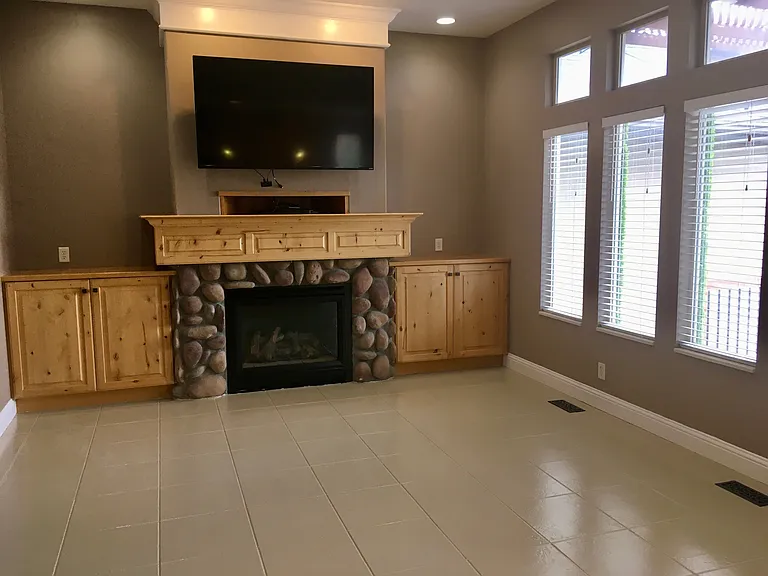 Living room with brand new epoxy coated tile flooring. Includes use of large screen flat panel tv.