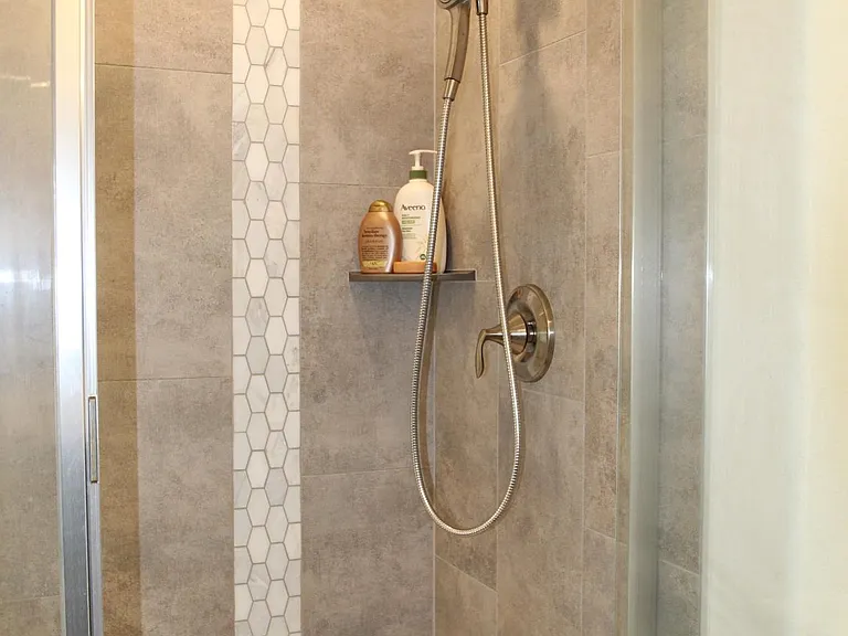 Primary bath has custom walk in shower