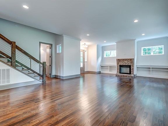 Contemporary stair rail, living room built -ins and brick surround on fireplace. NOTE: Fireplace is not function and not for ten