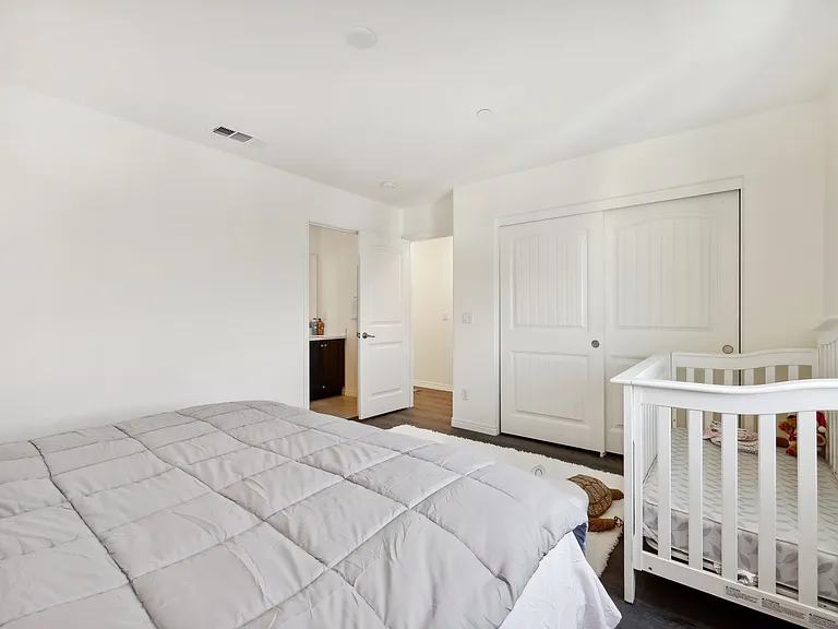 The standard-sized baby crib is equipped with safe, child-friendly toys.