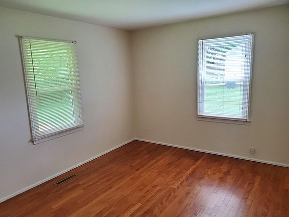 Spare bedroom with hardwood floors.