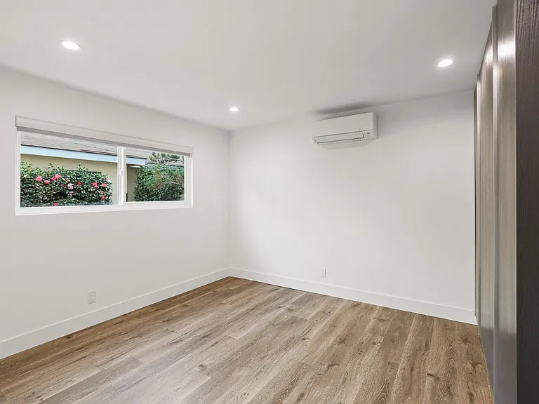 Bedroom with Reccessed Lighting, Closet Storage, and Window