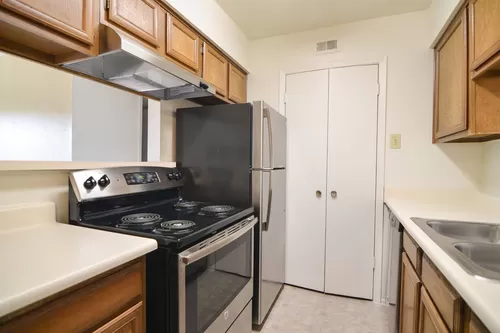 A kitchen with stainless steel appliances and full size washer dryer connections - Wildflower