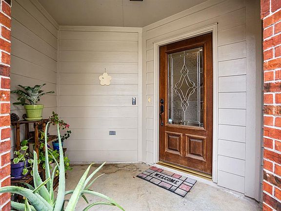 The home is located on a cul-de-sac street, has a gorgeous front elevation with an inviting front covered porch.