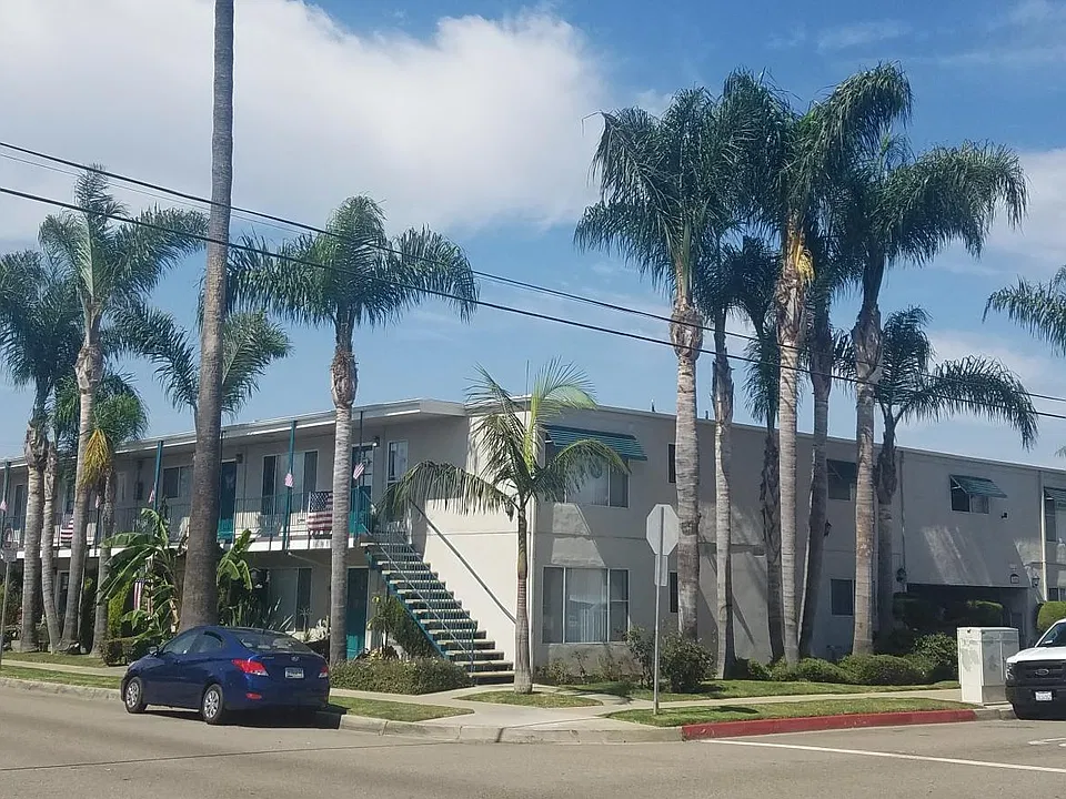 Corner property surrounded by palm trees