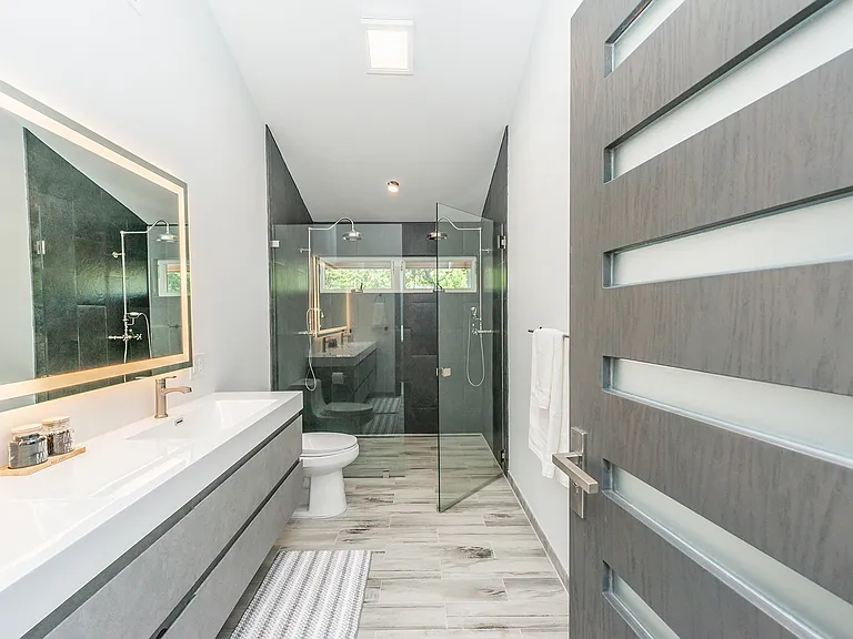 Primary bath with double vanity and glass-enclosed shower