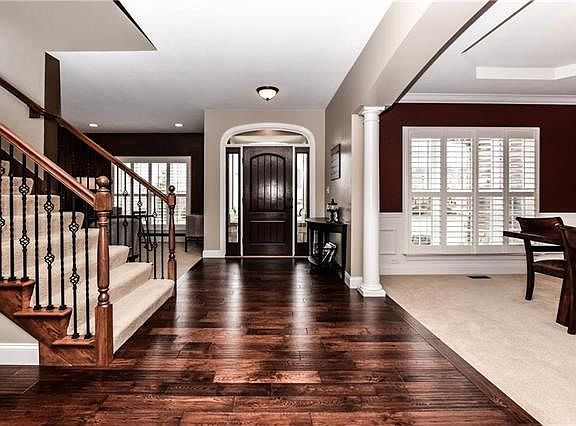 Grand entry foyer features Therma-Tru Fiberglass Classic Craft Door with Sidelights & Transom.
