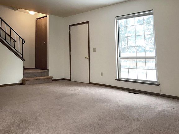 Large living room looking out over deck and trees