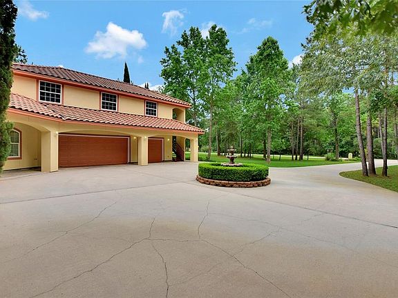 The large circle drive allows for easy access to the oversized garage and additional parking