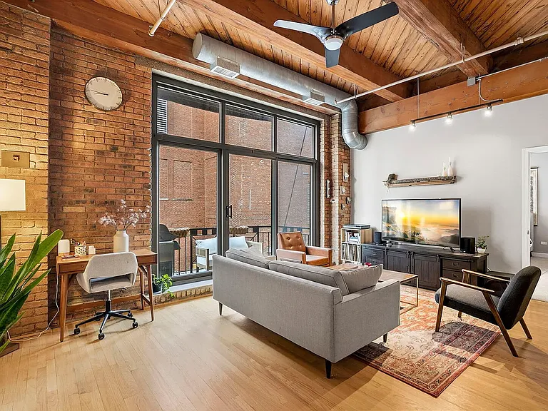 High ceilings with exposed brick make for a picturesque open living space
