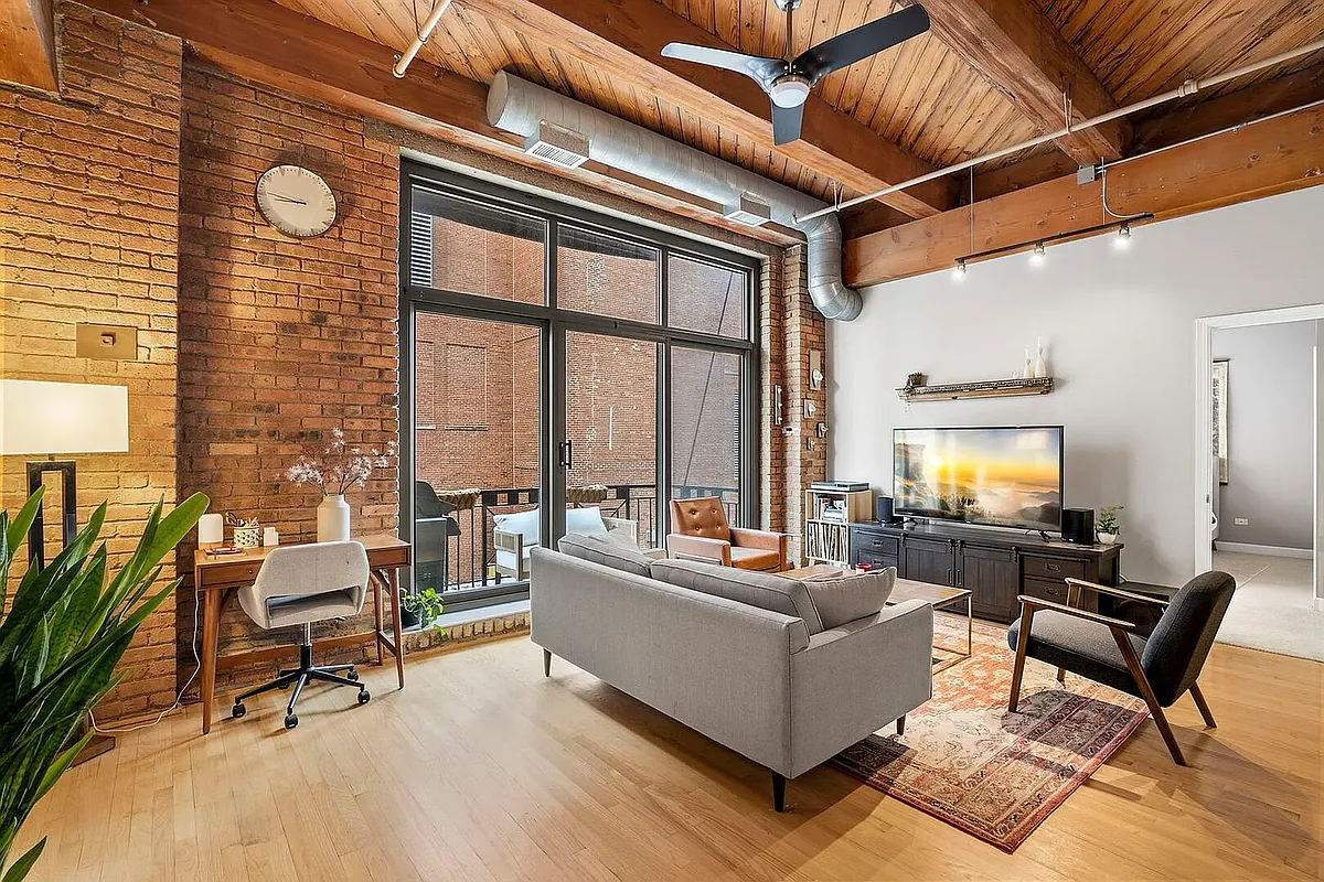 High ceilings with exposed brick make for a picturesque open living space - 1330 W Monroe St #216