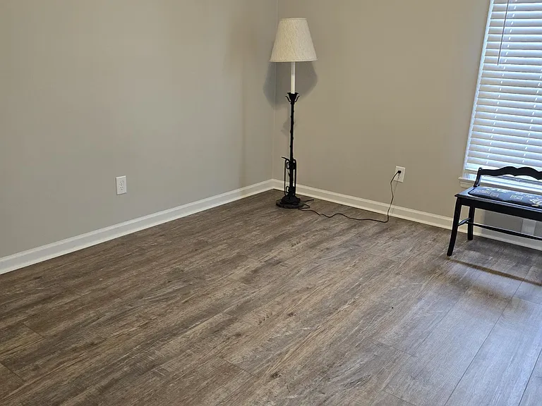 View of left bedroom from hallway entrance. 10.5' x 12' - good size for queen/king sized bed/bedside tables, and dresser. Water proof laminate flooring - easy to clean and very forgiving (doesn't show dirt). Color of grain works well with all colors.