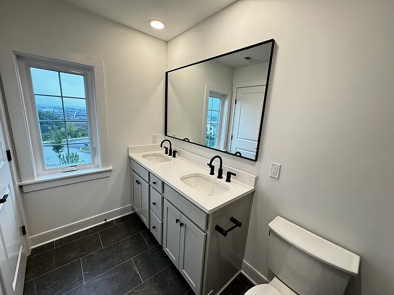 Two sinks with large mirror