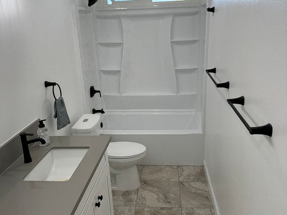 Newly renovated bathroom with spacious counter and storage.