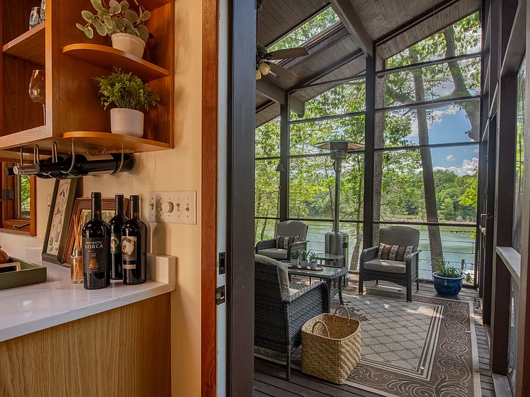 Screened porch overlooking water front.