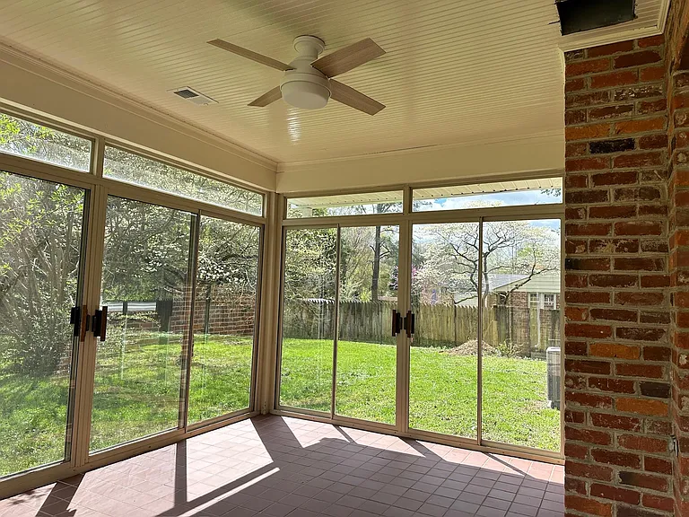Conditioned sunroom with sliding doors.