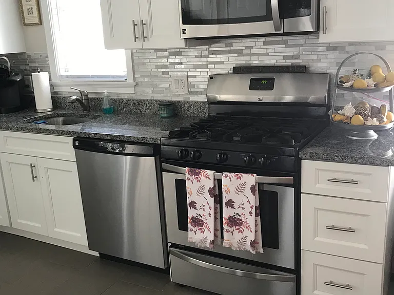 Kitchen with gas stove microwave and dishwasher.