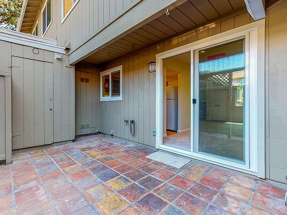 Back patio with gate to two parking places and extra storage