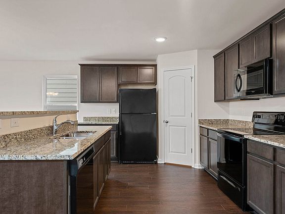 The kitchen is open to the dining room and living area.