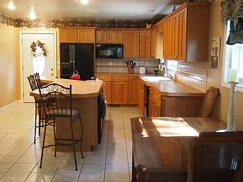 Wow!  What a terrific kitchen.  Lots of counter space for work area, a gas range, and all the appliances are included.  The island provides lots of seating space plus a great area for the table as well.