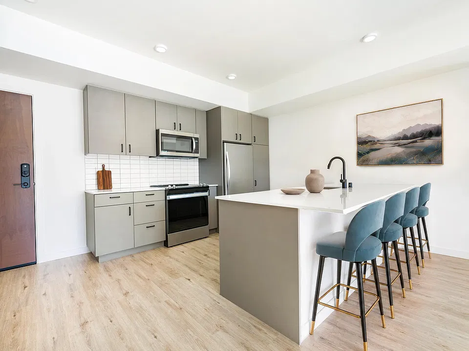 Premium homes feature oversized quartz islands with ample seating, contemporary flat-panel cabinetry, stainless steel appliances, and designer finishes that create a stylish space for cooking, dining, and entertaining.