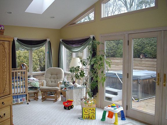 master bedroom with hot tub outside on deck, skylights