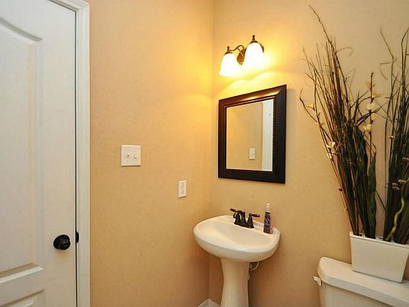 1/2 bath with pedestal sink downstairs.