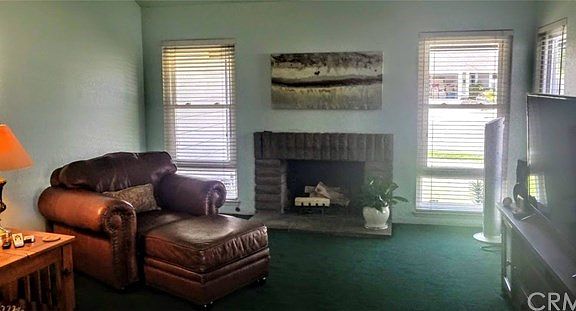 Upon entering the home you are greeted with a spacious living room with vaulted ceilings and accenting fireplace.