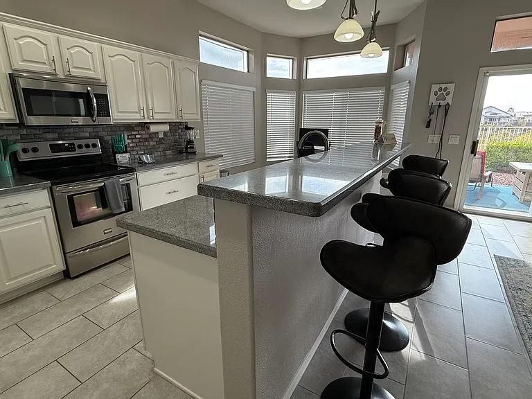 Open concept kitchen. View of patio door / back yard overlooking Golf Course.