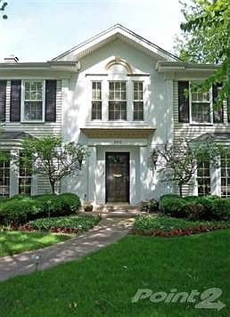Features Colonial Georgian design with a peaked center entry flanked by bay windows in the Living Room and Library.