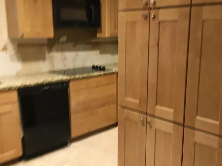 Kitchen has amble storage and ceramic counter top