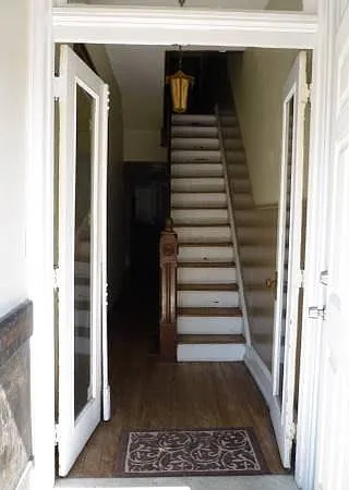 Stairs in from entrance to main floor and second floor