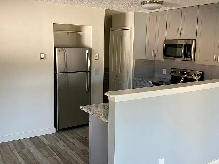 Closet door seem in back is where stacked washer/dryer are accessed.