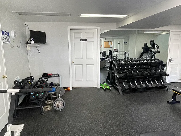Newly remodeled exercise room in basement of clubhouse. Free to all residents to use. Has complete set of weights, machines, and showers.