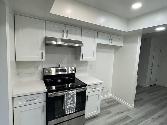 Kitchen , all new cabinets, stainless steel appliances. all hardwood through out