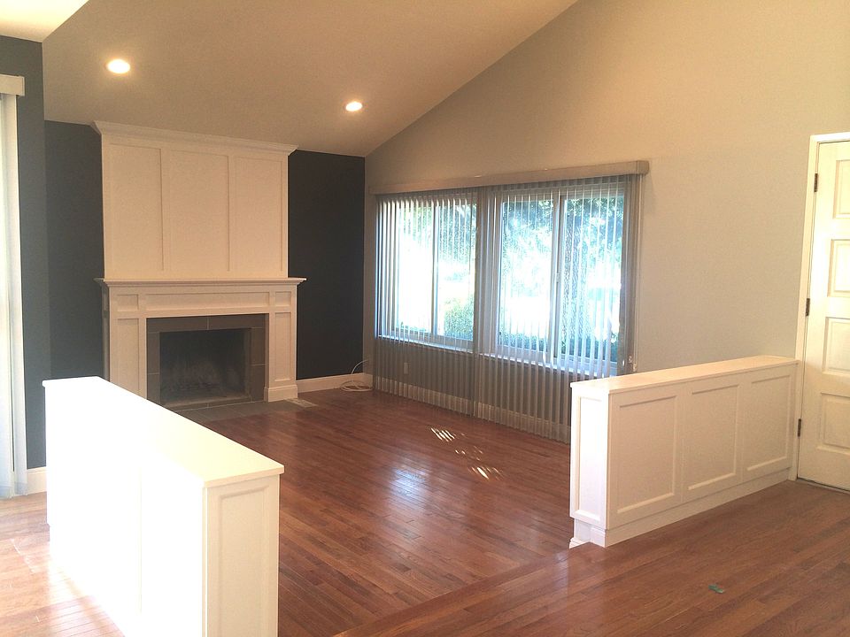 Living Room with Cathedral Ceiling and wood burning fireplac