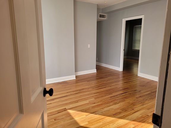 View from apartment entry door into dining area, bedroom #2 door seen.