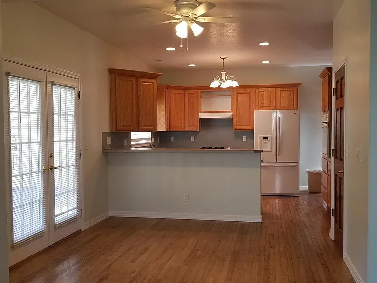 Newly painted kitchen and dining area. French doors to covered back deck.