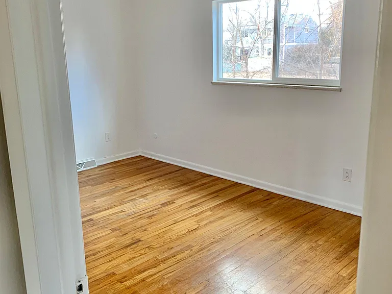1 of 3 upstairs bedroom with hardwood flooring