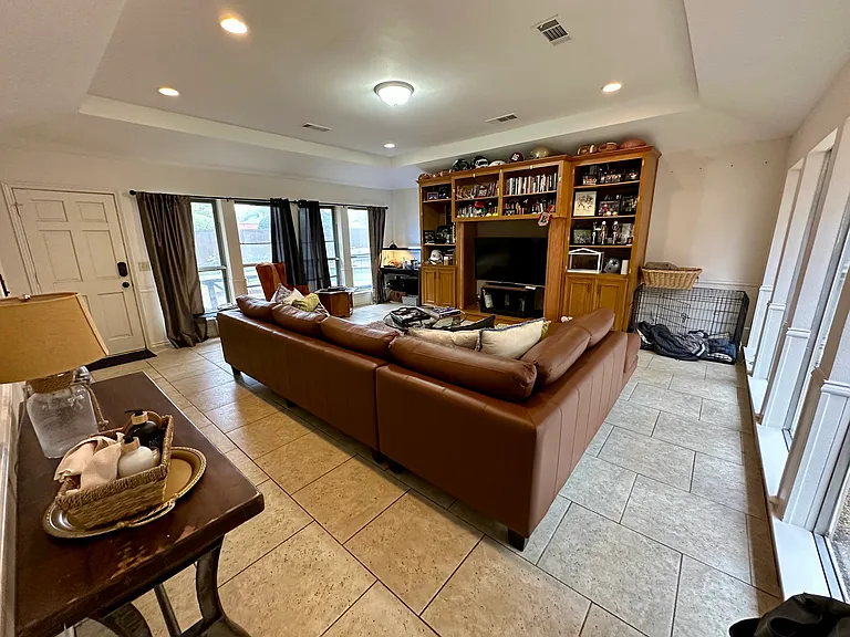Family room featuring a tray ceiling, recessed lighting.