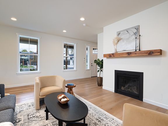 Living room with gas fireplace - Features and colors may differ