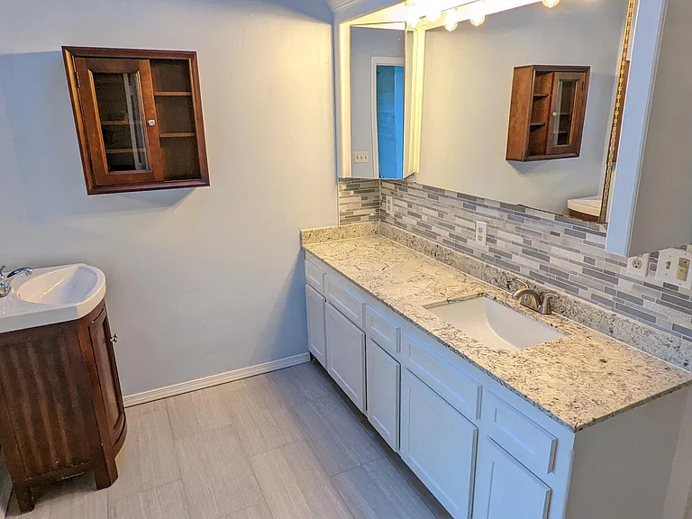 This recently remodeled bathroom comes with a modern backsplash, great natural lighting, huge counter space, separate "his & her" sinks, two built-in "medicine" cabinets, and a hookup for a heater. So it's always warm!