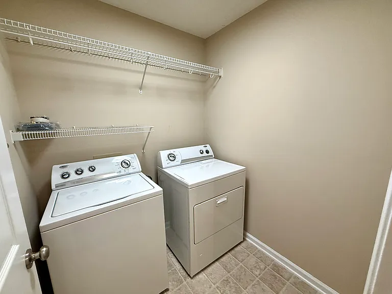 Laundry room with new flooring and shelving for storage